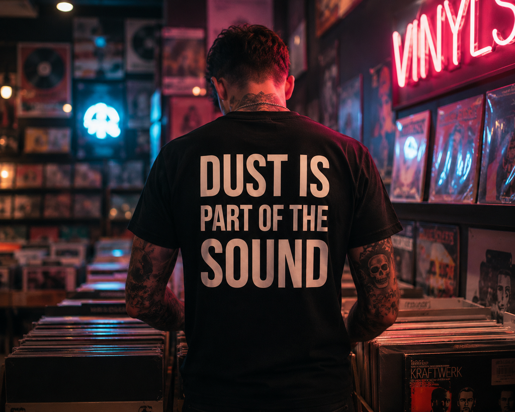 Person wearing a shirt with 'Dust is part of the sound' in a vinyl record store.