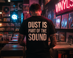 Person wearing a shirt with 'Dust is part of the sound' in a vinyl record store.
