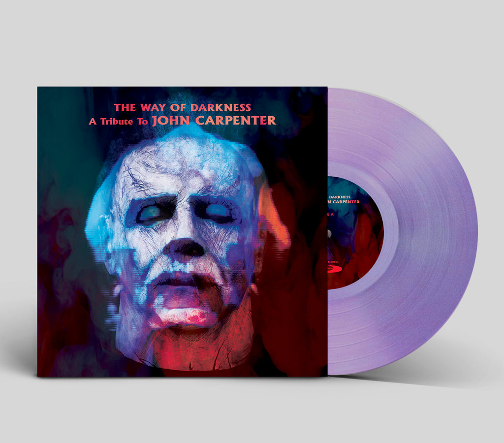Vinyl record with a cover featuring a stylized face and text 'The Way of Darkness: A Tribute to John Carpenter' on a light gray background.